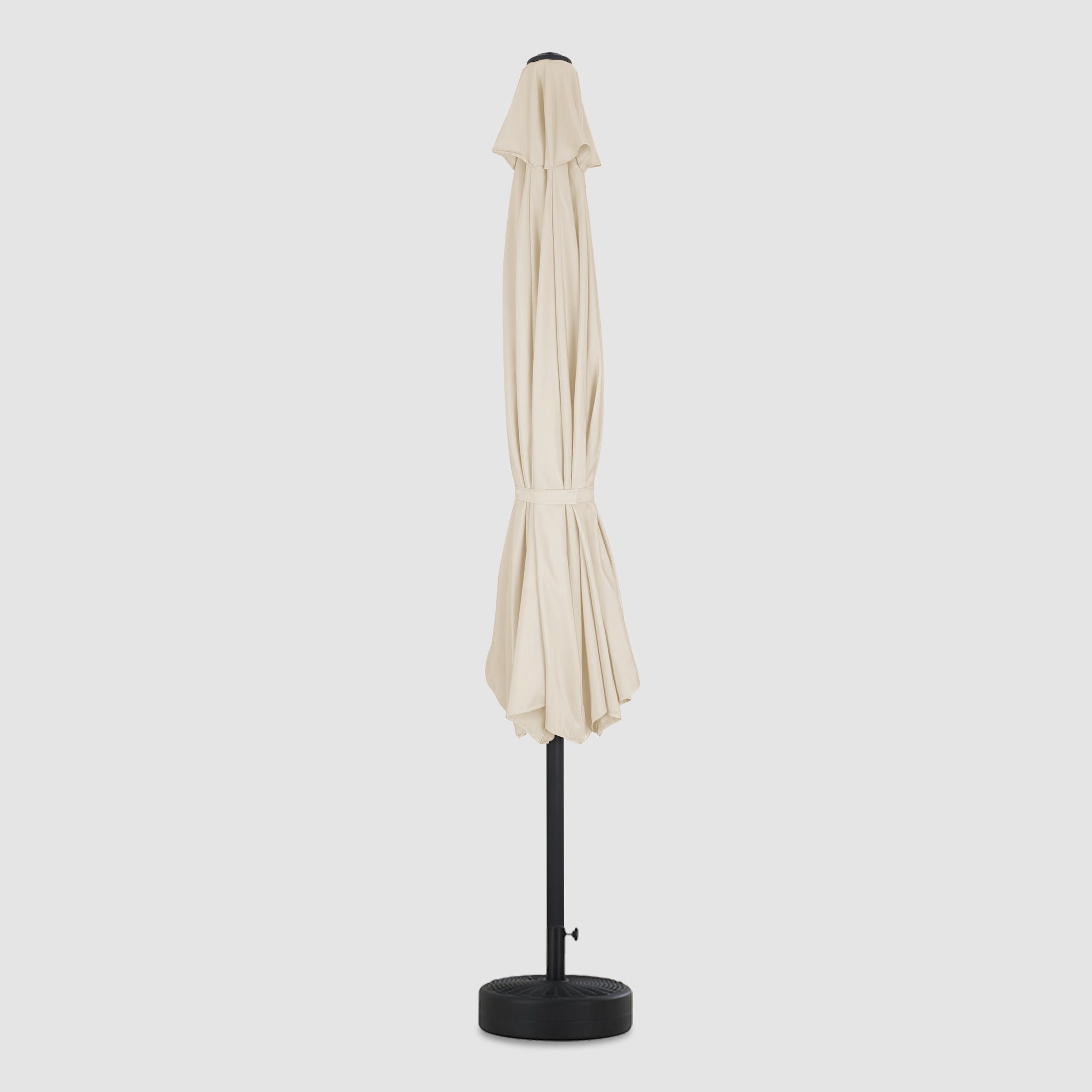 The long, folded Beige patio umbrella, as seen from the front, is of high quality and durability with a windproof hood.