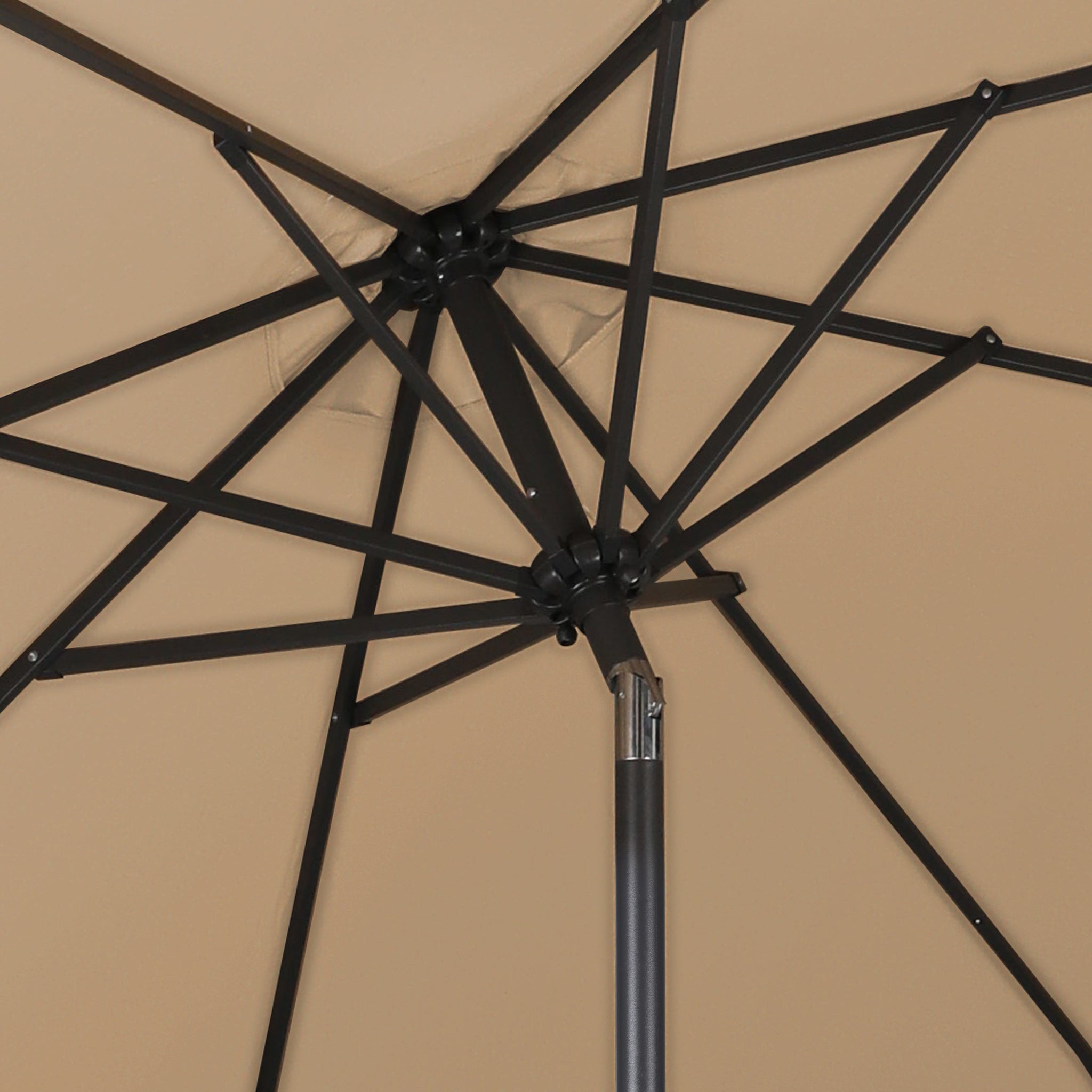 The inner skeleton of a good quality khaki patio umbrella as seen from underneath the umbrella.