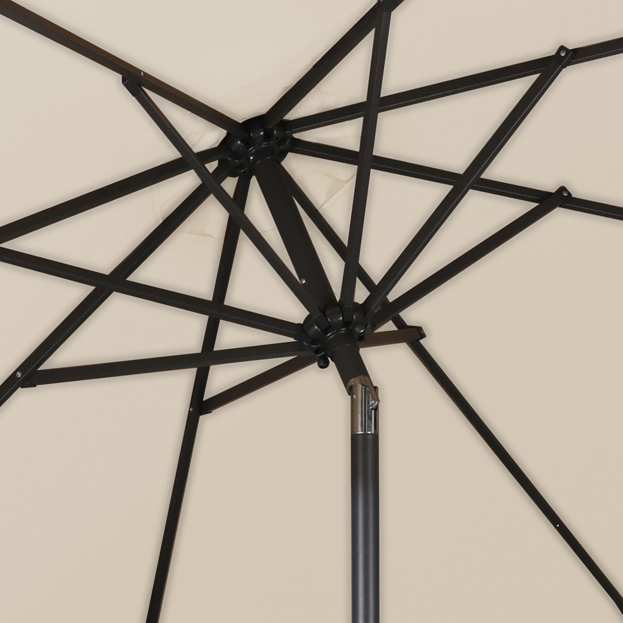 The inner skeleton of a good quality Beige patio umbrella as seen from underneath the umbrella.