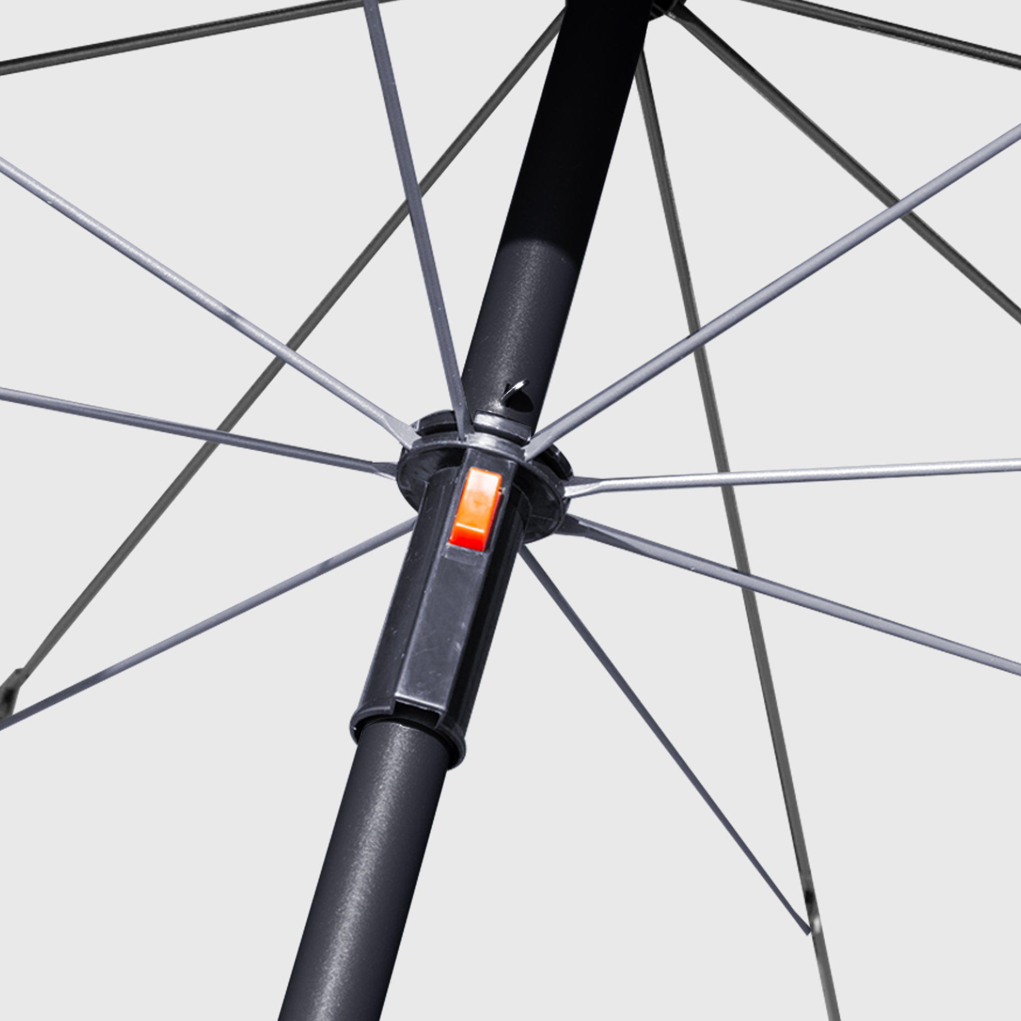 High-quality, durable black umbrella frame with close-up view and red button to open the umbrella.