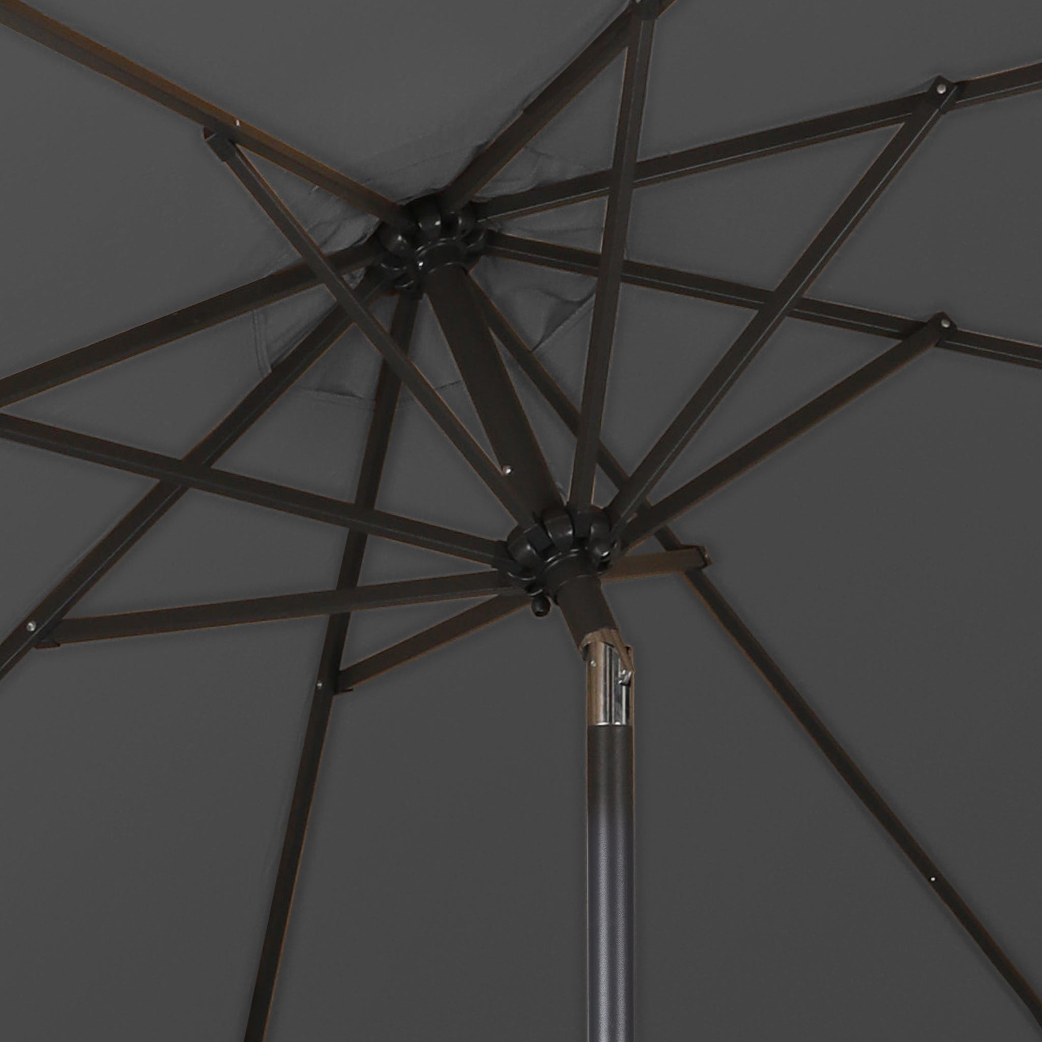 The inner skeleton of a good quality Dark Grey patio umbrella as seen from underneath the umbrella.